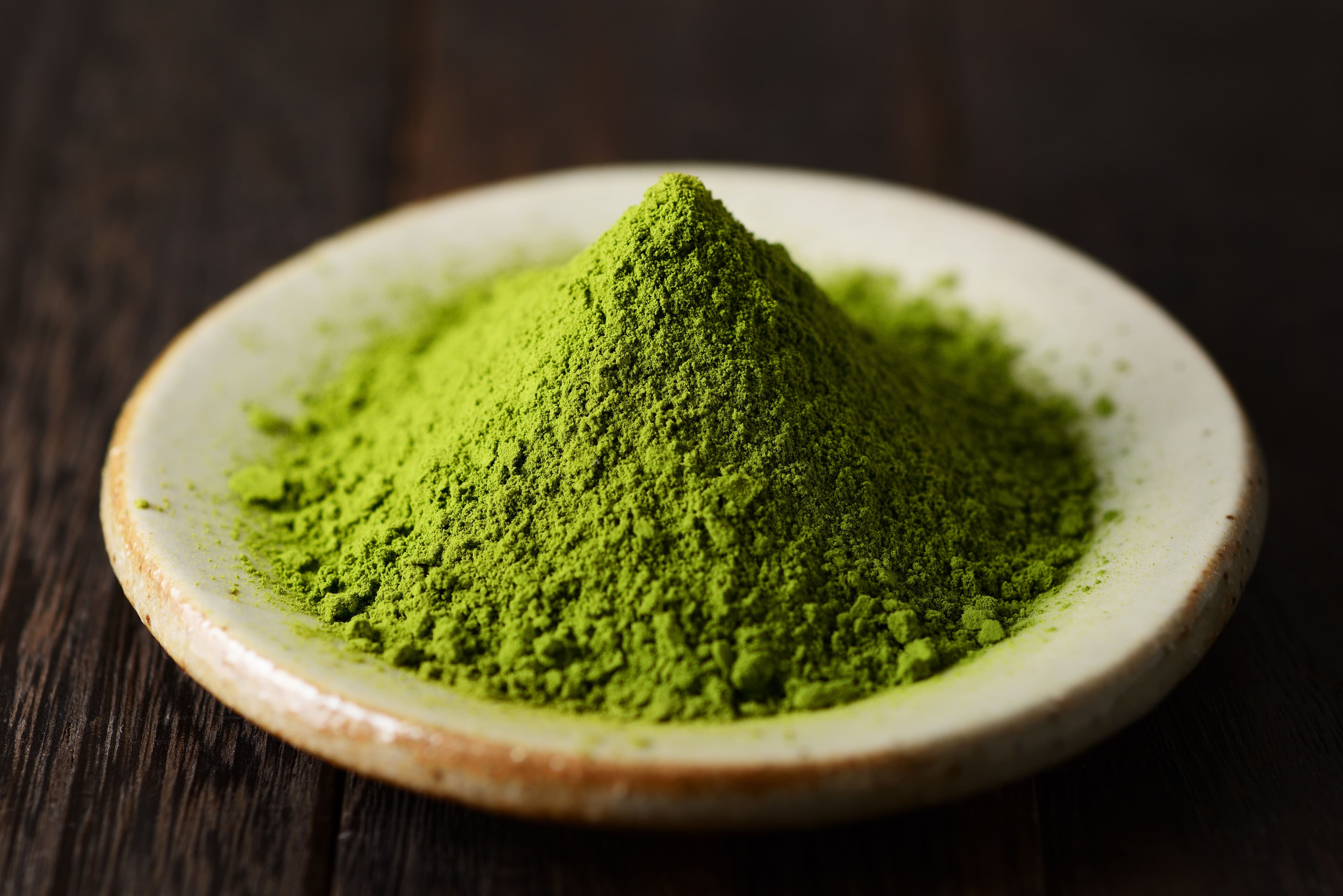 Close-up of premium matcha powder on a ceramic plate